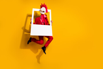 Poster - Photo of guy jump hold snapshot frame make picture wear cock polygonal mask red tux isolated yellow color background