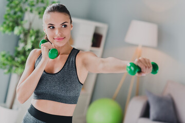 Canvas Print - Photo of strong pretty lady wear sport outfit smiling building arm muscles indoors home house