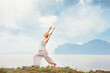 © luengo_ua - Senior caucasian woman doing yoga exercises with mountain on the background.