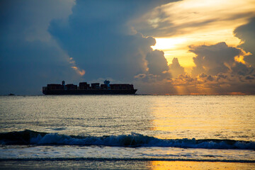 Sticker - USA, Georgia, Tybee Island. Ship off shore in storm at sunrise.