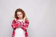 © Екатерина Елисафенко - red-haired young girl in a plaid shirt on a white background with a place for text shows NO