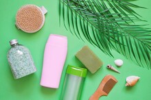 Mint Bath Salt, Pink Shampoo Bottle, Natural Shower Gel, Organic Soap, Wooden Comb And Massage Brush And Green Leaves. Flat Lay Still Life Beauty Photography, Top View Image For Design