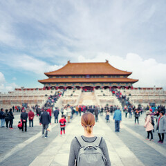Wall Mural - Enjoying vacation in China. Traveling young woman with rucksack in Forbidden City, Beijing.