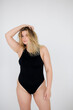 © kalinichenkod - attractive chubby girl in underwear on pink background
