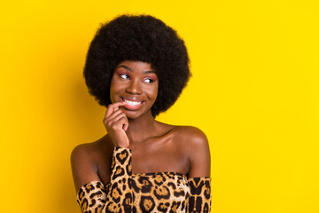 Poster - Portrait of attractive cheerful girl biting nail deciding copy space isolated over bright yellow color background