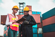 © InfiniteFlow - Industrial worker works with co-worker at overseas shipping container yard . Logistics supply chain management and international goods export concept .