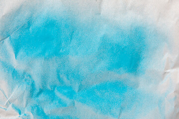 Sticker - blue spray paint on a white colored paper background