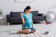 © LIGHTFIELD STUDIOS - happy pregnant woman looking at laptop while holding sports bottle.