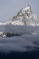 Poster - USA, Wyoming. Early morning light on the Grand surrounded by low clouds, Grand Teton National Park.