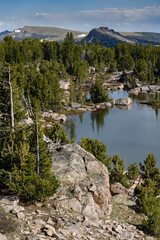 Wall Mural - USA, Wyoming. Alpine zone vista of lake, boulders with clouds, Beartooth Pass.