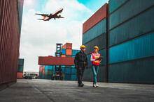 Industrial Worker Works With Co-worker At Overseas Shipping Container Port . Logistics Supply Chain Management And International Goods Export Concept .