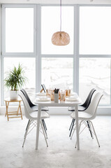 Wall Mural - White contemporary dining room with big window. A table served for Christmas. Loft intetior in white colors. Stylish Light room with an elegant firniture Comfort home. 