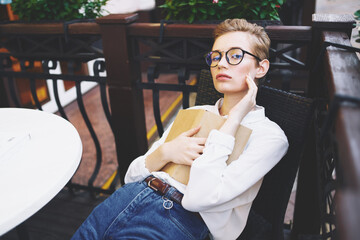 Wall Mural - female with glasses outdoors in a summer cafe rest communication