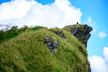 female hiker walking to the highest point at the mountain Phu Chi Fa mountain chiang rai Thailand.