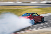 Red Drift Car / Race Car Drifting Around Corner Very Fast With Lots Of Smoke From Burning Tires On Speedway / Racetrack / Drift Track. Lexus Is300 V8. JDM Car.