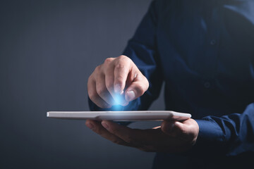 Wall Mural - Businessman using white digital tablet.