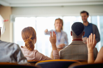 Wall Mural - Young participants having discussion at a business lecture in the conference room. Business, people, meeting, company