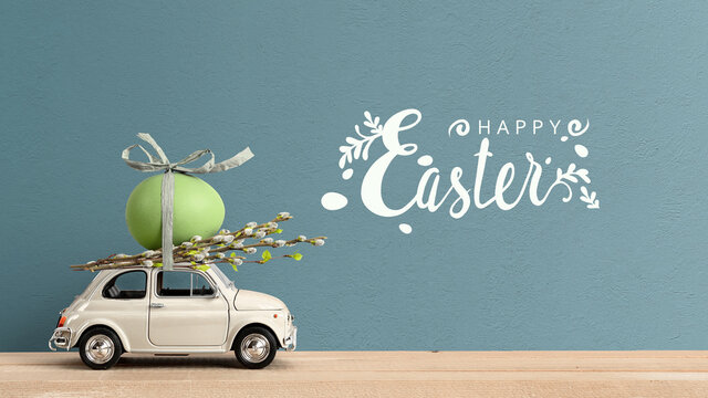retro car carrying an easter egg on the roof. happy easter text