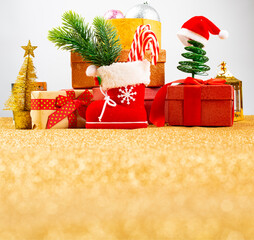 Sticker - Christmas gift box and fir tree branch on gold background. View with copy space