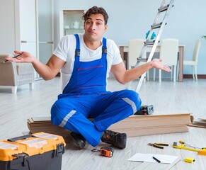 Repairman laying laminate flooring at home