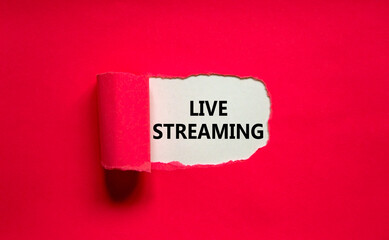 Live streaming symbol. Concept words Live streaming appearing behind torn pink paper. Beautiful pink background. Business, live streaming concept, copy space.