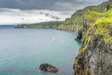 Fototapeta Mosty linowy / wiszący - Coastline with tall limestone cliffs, Rathlin Island and turquoise Atlantic Ocean near Carrick a Rede rope bridge, Wild Atlantic Way, Northern Ireland