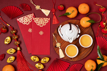 Wall Mural - Chinese new year festival decoration. Traditional lunar new year flat lay with green tea, red paper fans, cherry blossom. Top view