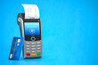 POS point of sale terminal for credit card payment on blue background.