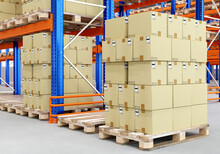 Warehouse Logistics. Logistic Center With Pallet Racks. Cardboard Boxes On Wooden Pallets. Logistics Business Concept. Distribution Warehouse From Inside. Nobody's Storage Space.