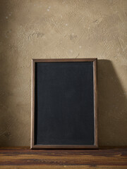 Wall Mural - blackboard in a wooden frame on a table