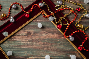 Christmas decoration ornament tiensel,ball and red frame n table wood background