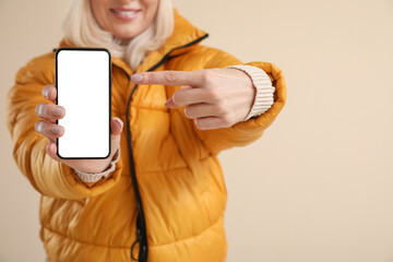 Sticker - Mature woman with modern mobile phone on color background