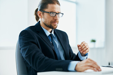 Wall Mural - male manager with glasses works in an office or computer