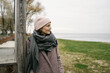 © contrastwerkstatt - Attractive middle-aged woman in pink knitted beanie and scarf