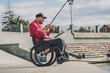 © romaset - Person with a physical disability in a wheelchair fishing from fishing pier.