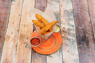 Wall Mural - Recipe for chicken fingers with sauces to dip on a wooden table with pepper and oregano