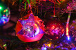 Old vintage glass toys and lights on Christmas tree. Merry xmas and Happy New Year decoration. Red mitten closeup background in low-key, high resolution.