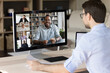 © fizkes - Professional employee man talking to diverse business group, watching learning webinar, training of Black coach, negotiating to team members, coworkers, discussing project online on virtual chat