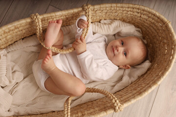 a cute blonde-haired baby in a white suit lies in a straw-woven cradle. a child's dream. high-qualit