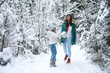 © alexkich - Young family for a walk. Mom and daughter are walking in a winter park.