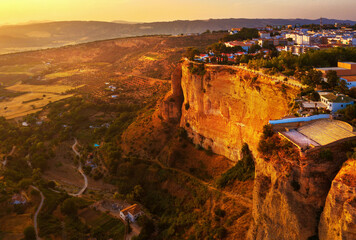 Poster - Ronda, Spain. Aerial evening view of New Bridge over Guadalevin River in Ronda, Andalusia, Spain. View of the touristic city with arena at the background