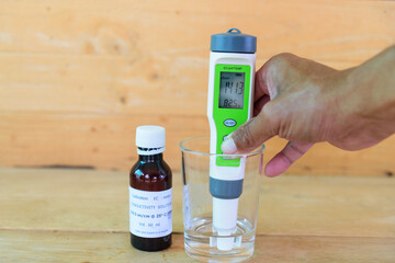 Wall Mural - The man calibrate Ph meter before use it for tester