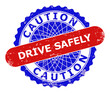 Bicolor CAUTION DRIVE SAFELY badge. Blue and red CAUTION DRIVE SAFELY seal with rosette and rounded rectangle design elements. Rounded rectangle framed CAUTION DRIVE SAFELY seal in red, blue colors,