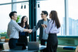 © visoot - Successful young business people are handshaking and smiling in office,Meeting business partners concept.