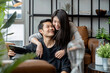 happiness asian people couple working at home with cheerful and happiness hugging together with love and joyful,asian marry couple working with tablet in living room at home with hug support husband