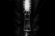 White Lock With A Zipper On Clothes, Jacket, Jacket Close-up On A Black Background. Lightning.