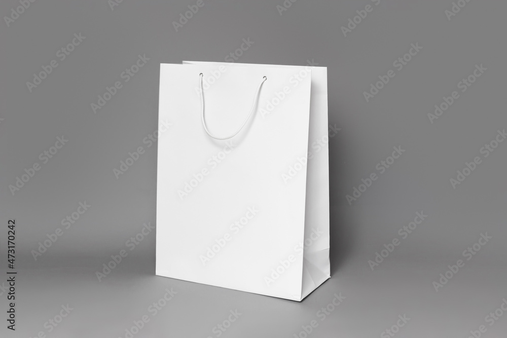 Mockup of white shopping bag isolated over dark grey paper background ...