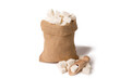 White sugar cubes in burlap. And a wooden scoop. On white background.