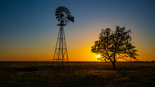 Silhouetted windmill at sunset