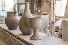 A Row Of Freshly Made Clay Cup, Vase And A Jug At A Pottery